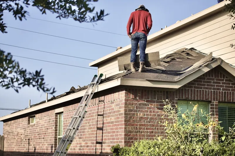 Professional roofer working on a residential roof in North Park